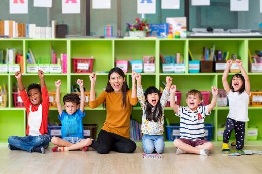 classroom teacher and children happy